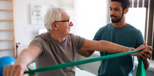 Older man receiving physical therapy