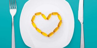 Plate with fish oil supplements shaped as a heart