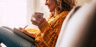 Women sitting on couch with tea